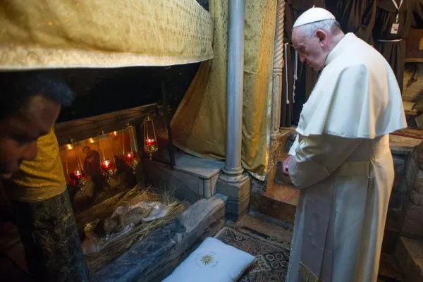 Papa Francesco nel 2014 in preghiera nella Grotta della Natività a Betlemme / Vatican Media / Custodia di Terra Santa